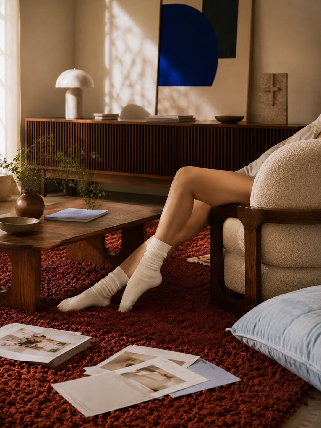 Detail: a figure beside the walnut Llano sideboard under a cobalt canvas